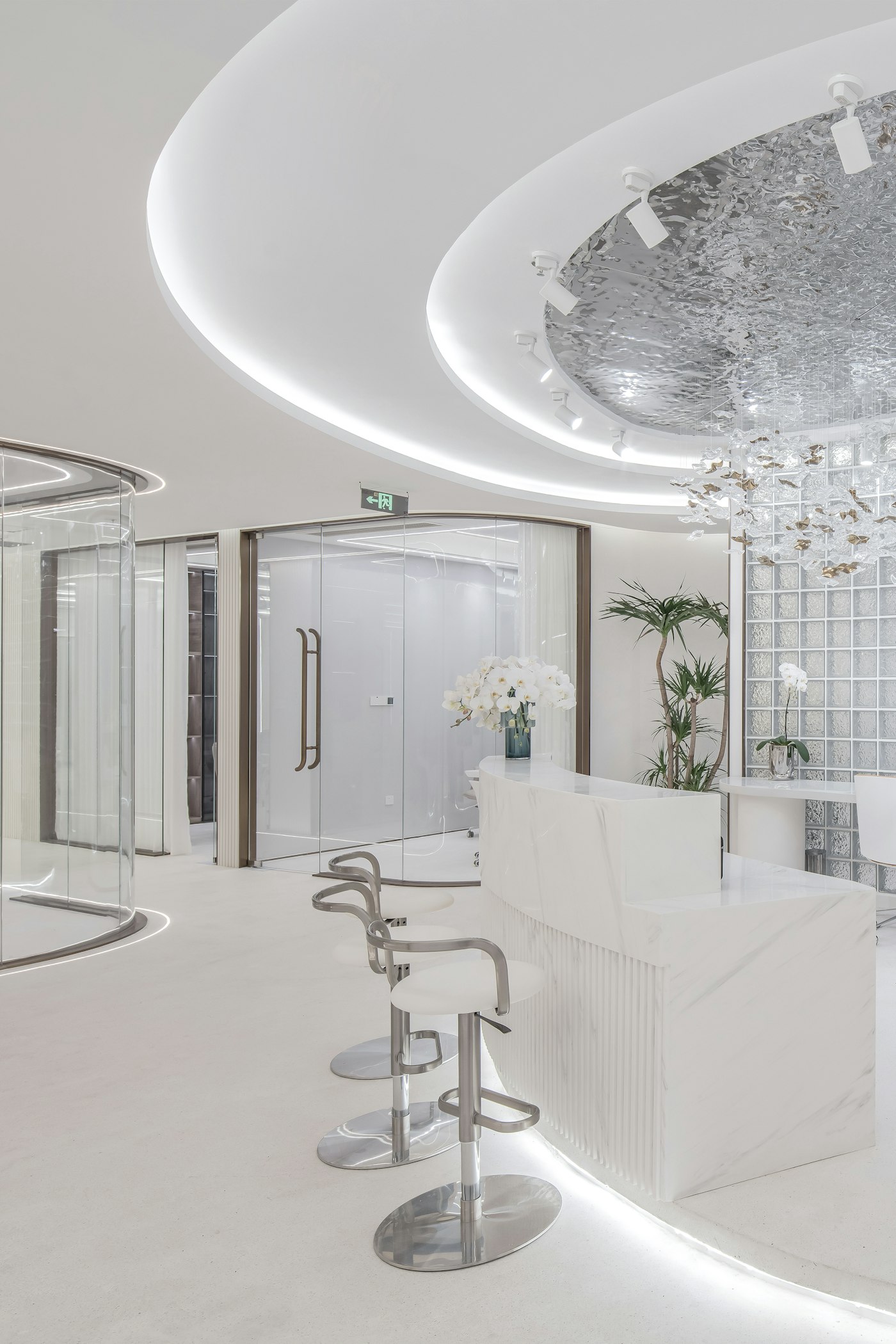 Bright white clinic interior with a sculpted ceiling and reception seating